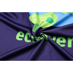 A close-up of a soft, vibrant purple fabric featuring a colourful design and a logo.