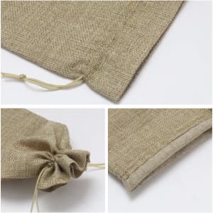 A drawstring bag in a natural beige colour, featuring a textured fabric and a simple closure. It has a logo.