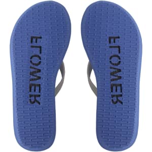 A pair of blue rubber thongs with a textured sole, featuring a branding logo on the footbed.