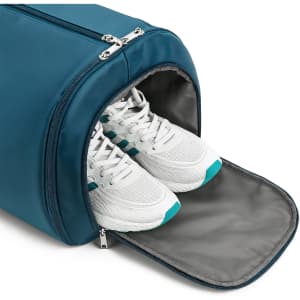 A teal duffel garment bag with a compartment containing white sneakers, showcasing a sleek design.