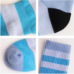 Merino wool socks featuring a light blue design with black and aqua accents, showcasing various sock details.