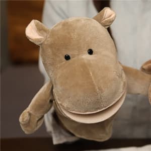 A plush hippopotamus hand puppet in a light brown colour, featuring black eyes and soft fabric.