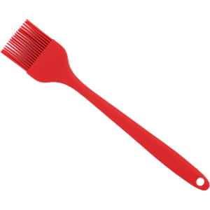 A red pastry brush with a flexible silicone head and a long handle, featuring a hole for easy hanging.