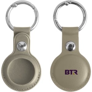 A PU leather AirTag holder in light beige, featuring a keyring and a logo on one side.