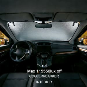 A bubble aluminium car sunshade in silver, fitted inside a car, blocking sunlight from the front windshield.