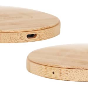 A bamboo wireless charger with a smooth, circular design and a USB-C port on the side. It has a natural wood finish.