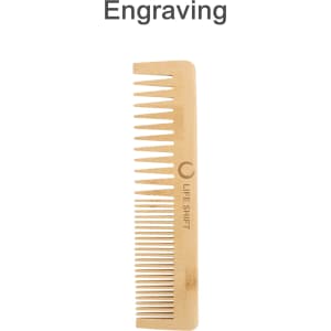 A bamboo comb with fine and wide teeth, featuring a logo and engraving, in a natural wood colour.