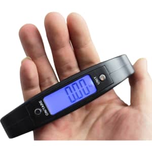 A black digital luggage scale held in a hand, displaying a blue backlit screen with a weight reading.