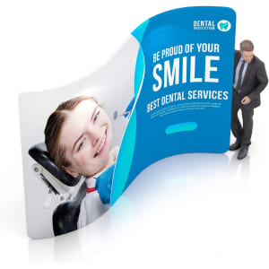 A curved, vibrant display wall featuring a smiling woman in a dental chair, with a logo and professional design.