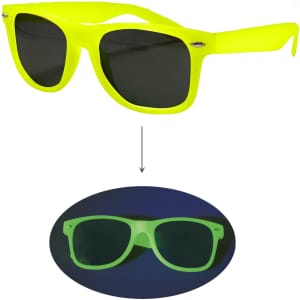 Glow in the dark sunglasses in bright yellow with dark lenses, displayed against a dark background. Features a logo.