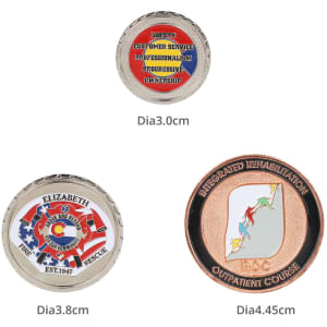 Commemorative gold coin pins in various designs, including red, blue, and gold colours, featuring a logo and inscriptions.