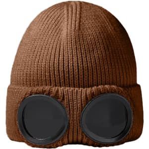 A brown beanie with black goggles attached at the front, displaying a knitted texture.