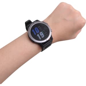 A round black smart watch is displayed on a wrist, featuring a digital screen with blue numbers.
