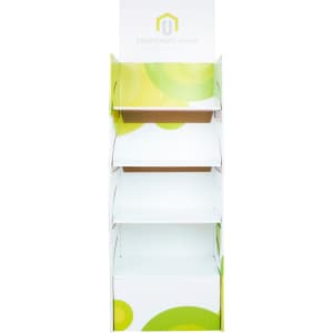 A white cardboard floor display with green circular designs and multiple shelves for product placement.