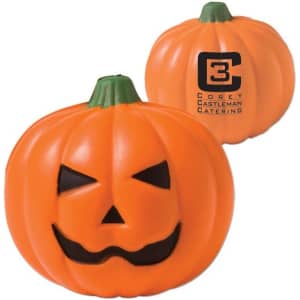 An orange pumpkin stress reliever with a smiling face and black features, featuring a logo on one side.