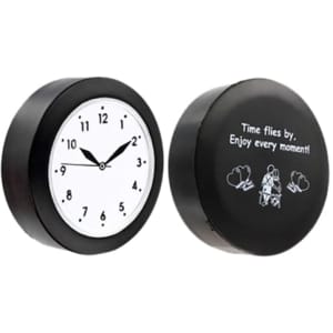 A black quart clock-shaped stress reliever featuring a white clock face and a motivational message on the reverse side.