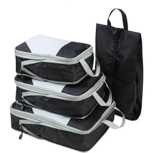 Three black packing cubes with grey accents and a black pouch, featuring handles for easy carrying.