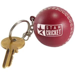 A maroon cricket ball stress reliever attached to a metal keyring alongside a key, featuring a logo.