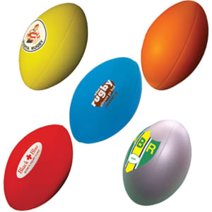 A collection of five stress balls in various colours, shaped like rugby balls, with different logos displayed.