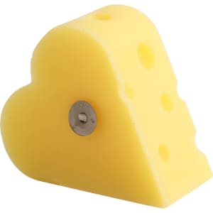 A heart-shaped yellow candle resembling a wedge of cheese, featuring holes and a silver base.