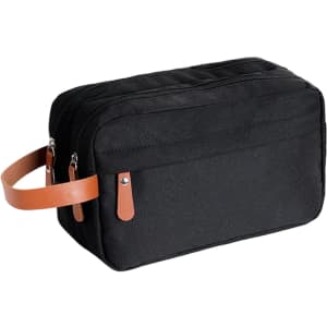 A black toiletry bag with a tan leather handle and zippers, featuring a simple and classic design.