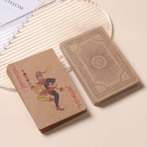 Kraft paper playing cards in brown, featuring a Joker design on one and a decorative back on the other.