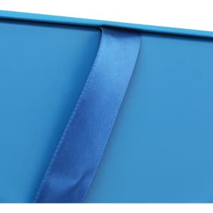A blue custom gift box with a glossy finish and a matching satin ribbon. It features branding on one side.