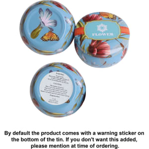 A tin candle set featuring floral designs in pastel colours, including three round tins and one larger tin.