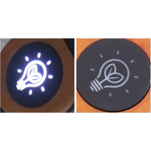 A round light bulb design featuring a plant element, illuminated against a black background.