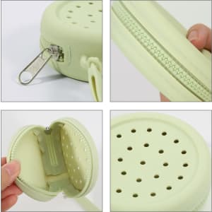 A round, pale green silicone pouch with a zipper and perforated holes, featuring a silver clip and textured interior.