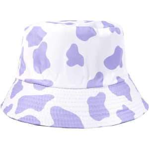 A bucket hat featuring a white base adorned with purple cow print patterns and a striped brim.