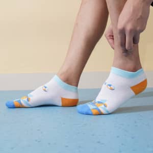 Low cut custom pattern socks in white, blue, and orange with a colourful design, featuring a logo on the side.