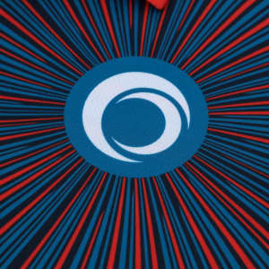 A blue and red polo shirt featuring a circular logo at the centre and radiating lines around it.