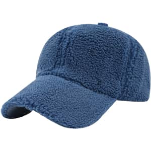 A blue lamb fur baseball cap with a curved brim and a structured crown, featuring a logo on the side.