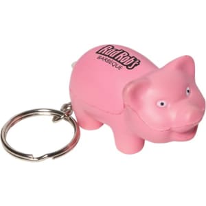 A pink pig-shaped keyring with a silver keychain attachment, featuring a logo on its side.
