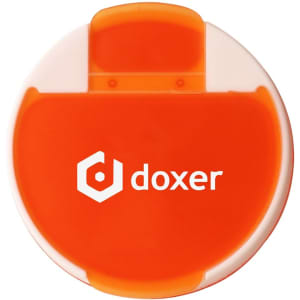 A round pill box in orange and white with a logo on the front.