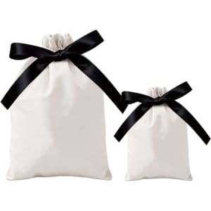 Two cream drawstring gift bags with black ribbon bows, one larger and one smaller, both featuring a logo.