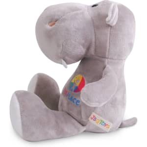 A grey hippopotamus plush toy with a colourful logo, featuring a rounded head and soft body, sitting upright.