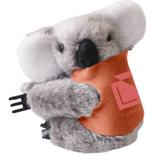 A grey koala plush toy with a brown pouch, featuring a logo on the pouch.