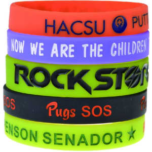 A set of debossed silicone wristbands in red, green, purple, blue, and black, featuring various logos and text.