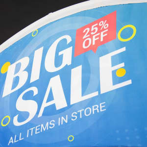 A vibrant blue tent billboard banner featuring the text "Big Sale" with a red "25% Off" highlight and circular accents.