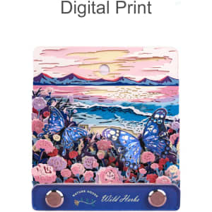 A 3D paper-cut sculpture notepad in vibrant blues and pinks, featuring butterflies and floral designs, with a hanging loop.