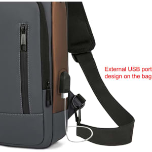 A grey and brown anti-theft sling bag with an external USB port and adjustable strap. It features zippered compartments.