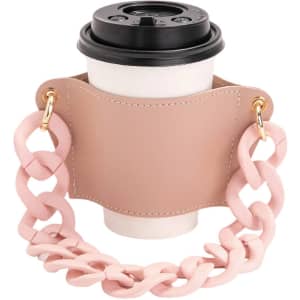 A drink bottle holder in pale pink with a chunky acrylic strap, featuring a coffee cup placed inside.