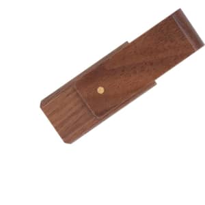 A wooden flash drive in a dark brown finish with a small gold dot, featuring a sleek, minimalist design.