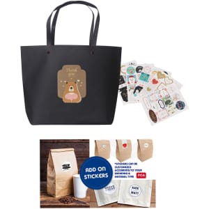 A black paper bag with handles, featuring a cute bear design, accompanied by assorted stickers.