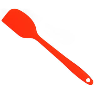 A red spatula with a flat, flexible head and a long handle, featuring a hole for hanging.