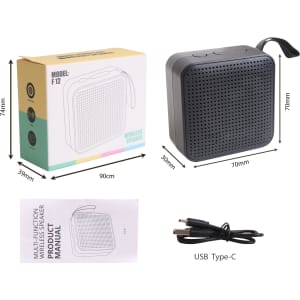 A portable wireless Bluetooth speaker in black, with a square design and a USB Type-C cable and manual included.
