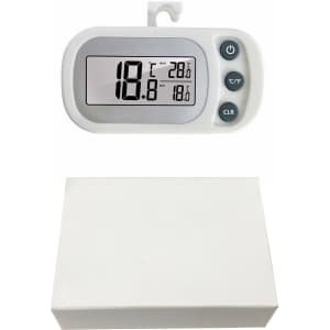 A white ambient thermometer with a digital display showing temperature readings, positioned above a plain white box.