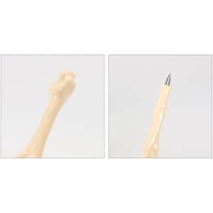 A pen shaped like a finger bone, featuring a creamy beige colour and a silver pen tip. It has a logo on the side.